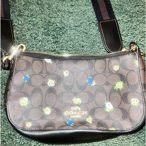 Brown w/flowers small coach cross body. Looks very good, inside and out.